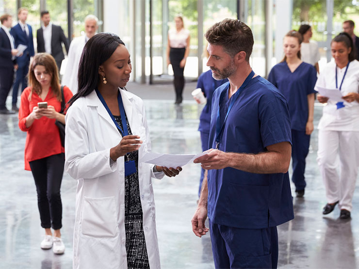 Medical professionals in an hospital entrance.